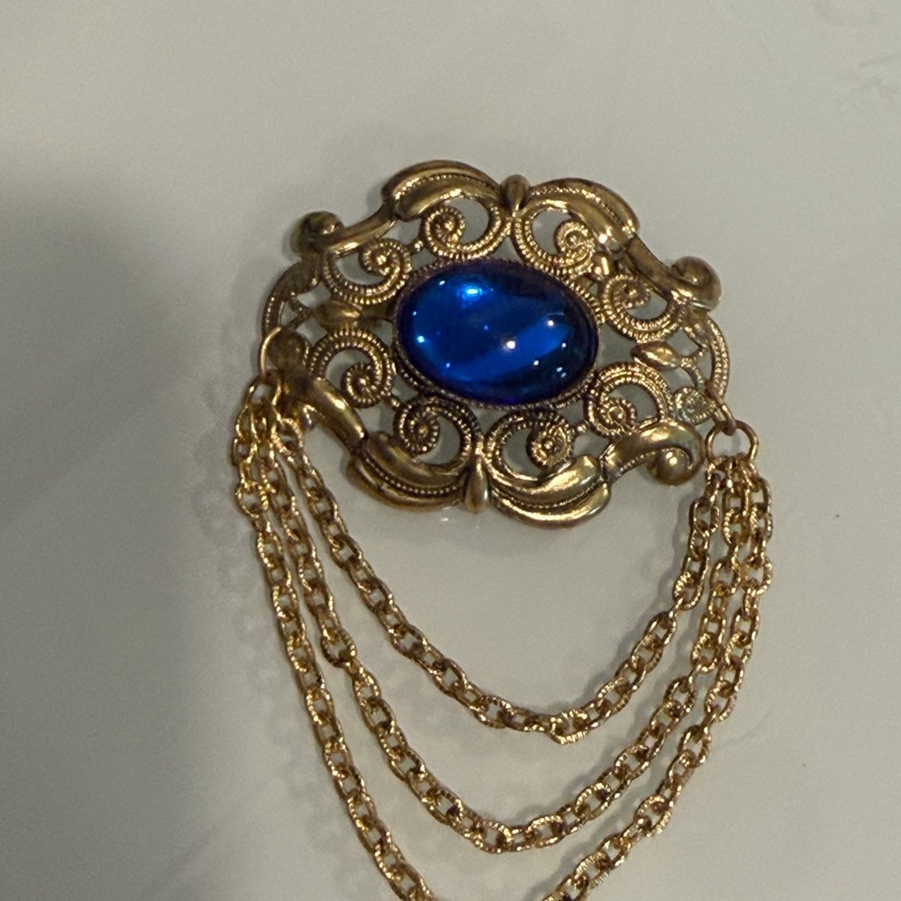Gold Filigree Brooch with Blue Cabochon and Chain Accent signed West Germany.